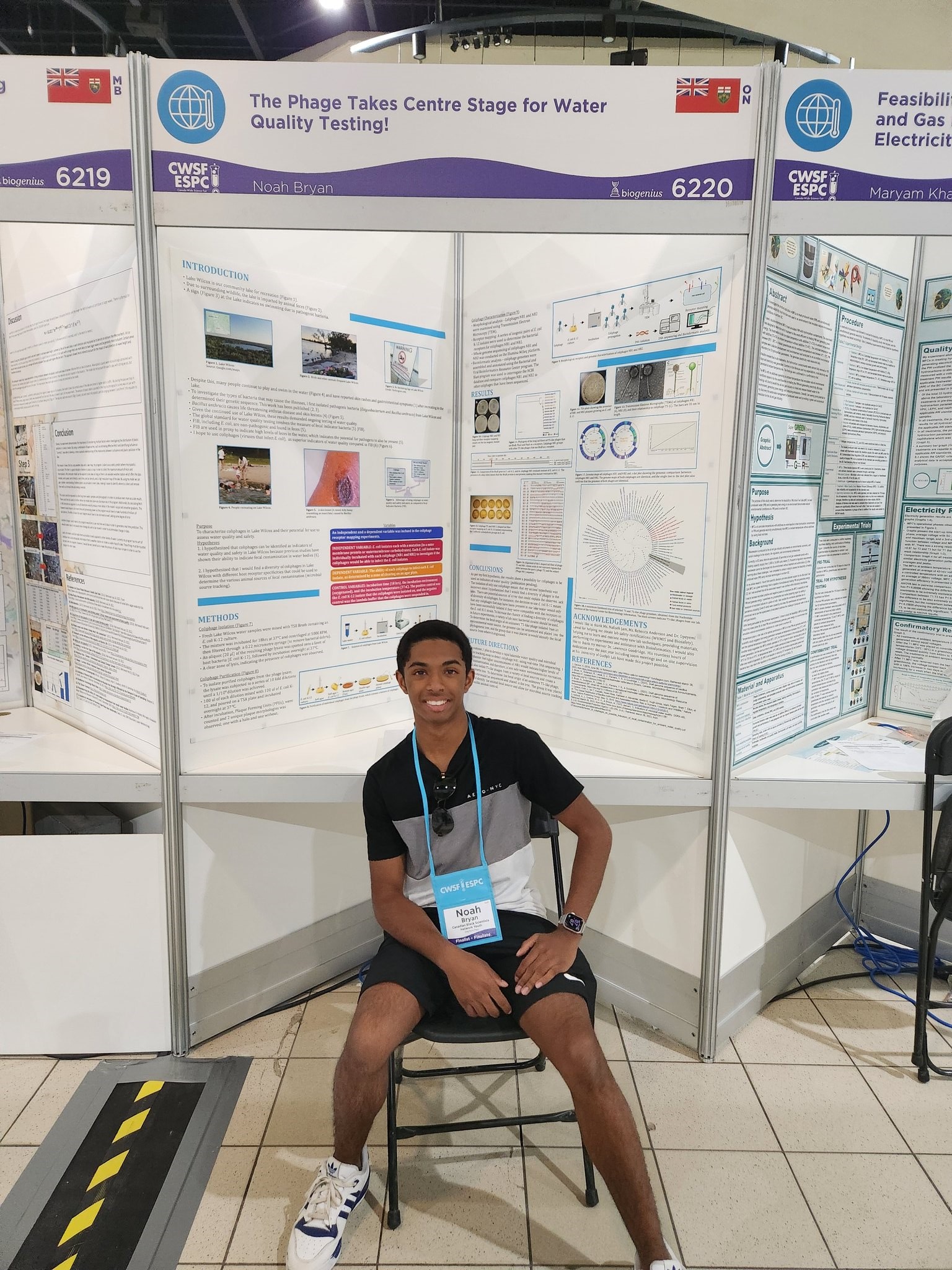 Teen sits in front of a poster display.